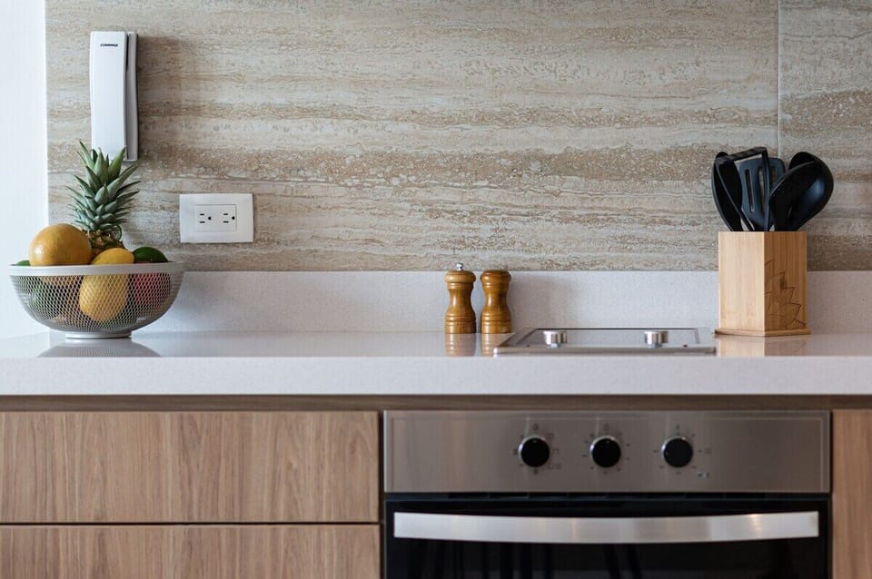 Prepare a sumptuous  meal on the granite counter top of our full kitchen while enjoying the fresh air from the open glass door of the balcony.