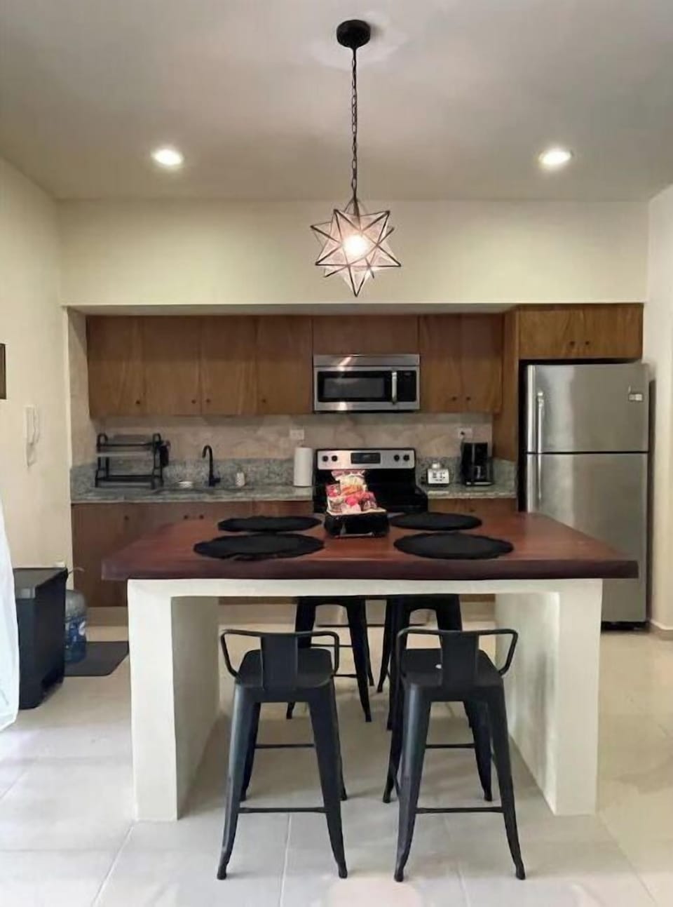 The kitchen has counter seating and is fully stocked for meals at home