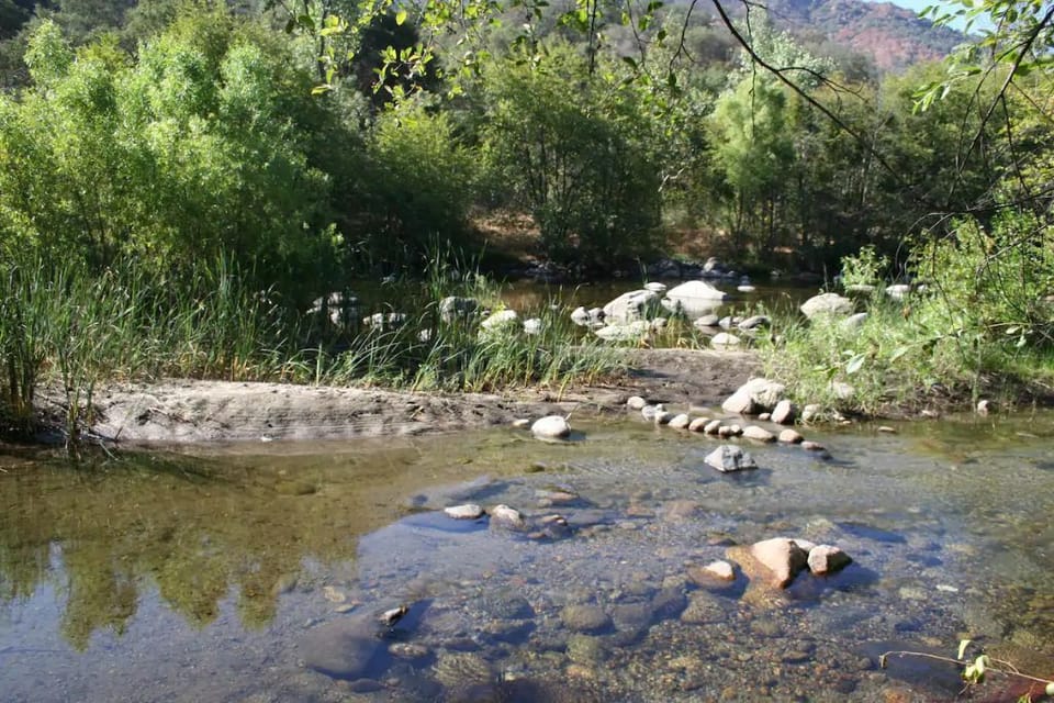 The same location is a quiet spot on the river in late summer.