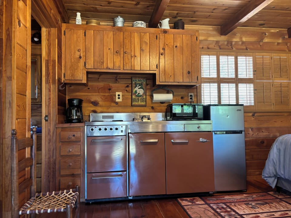 The kitchen with an oven, microwave, and fridge. 
