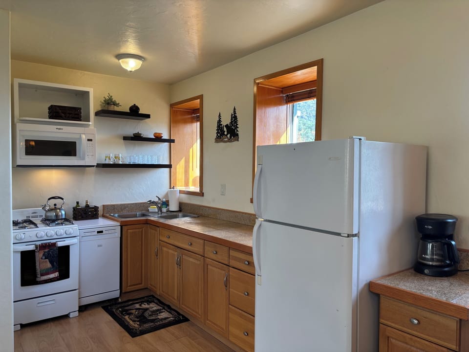 The kitchen with a full fridge, oven and stovetop, and plenty of counter space. 