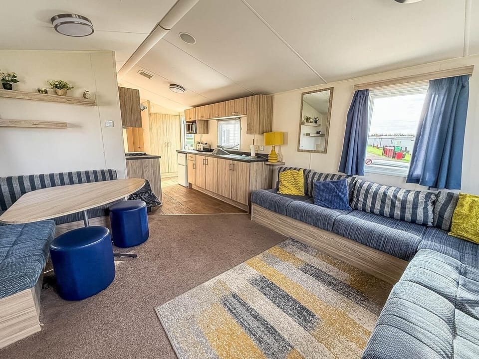 Cozy living and dining area with vibrant seating and natural light