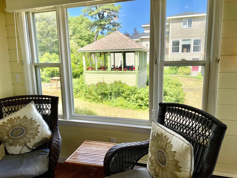 Seating in sunporch, view to gazebo