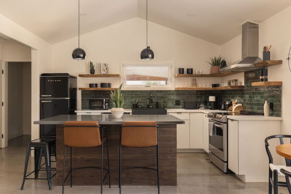 A chef’s kitchen with wine fridge + pour-over coffee bar