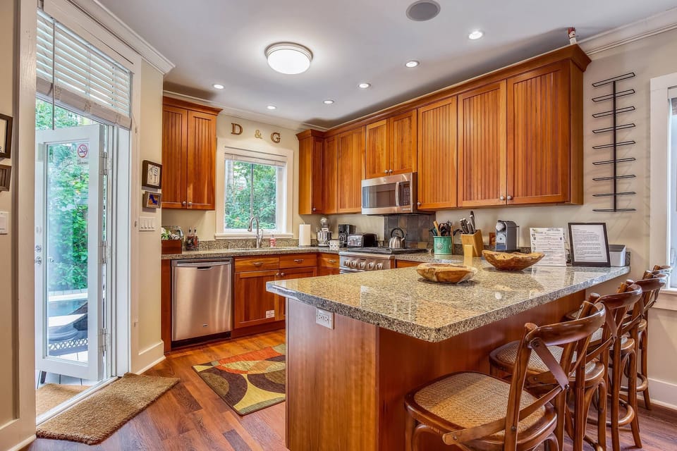 Kitchen features modern appliances and a counter-top breakfast bar.