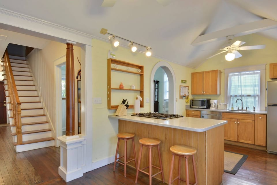 Spacious kitchen features a countertop breakfast bar.