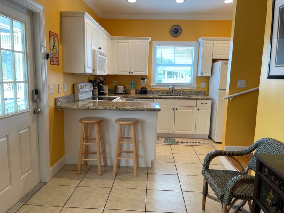 Kitchen features a breakfast bar.