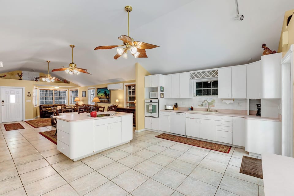 Spacious open layout with a bright kitchen, vaulted ceilings, and a cozy living area for gathering.