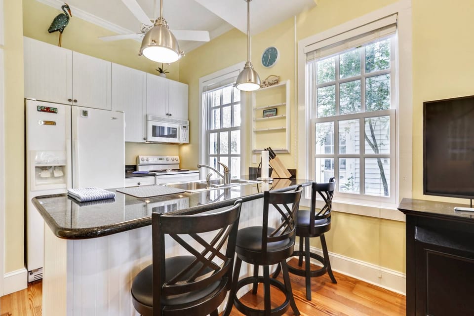 Kitchen features an island with a countertop breakfast bar.