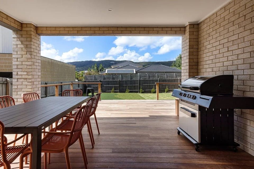 Covered area of the deck with table and bbq