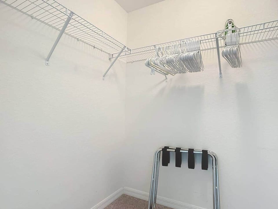 Spacious walk-in closet includes luggage racks