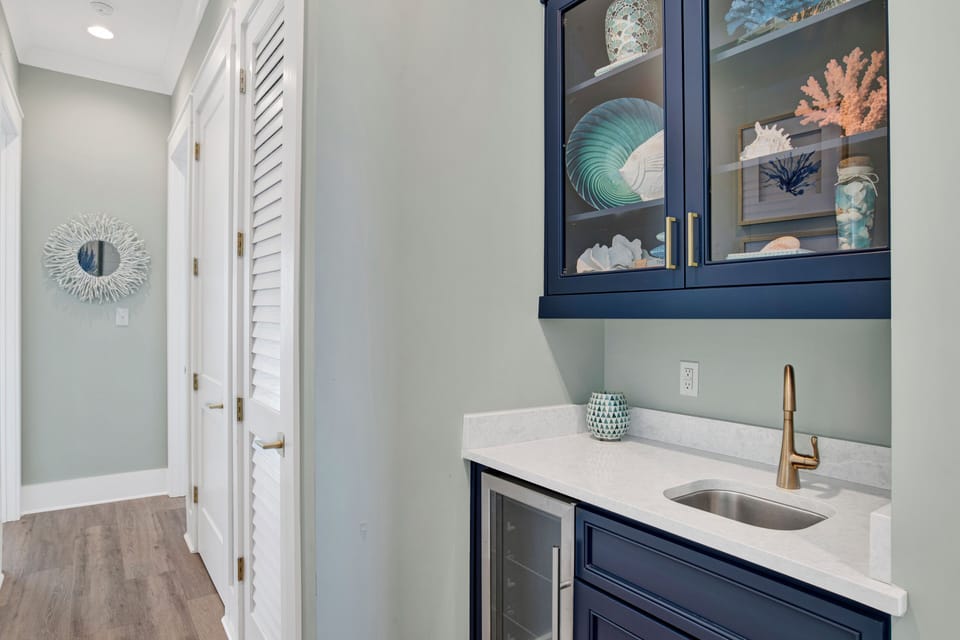 The wet bar features a sink and wine cooler