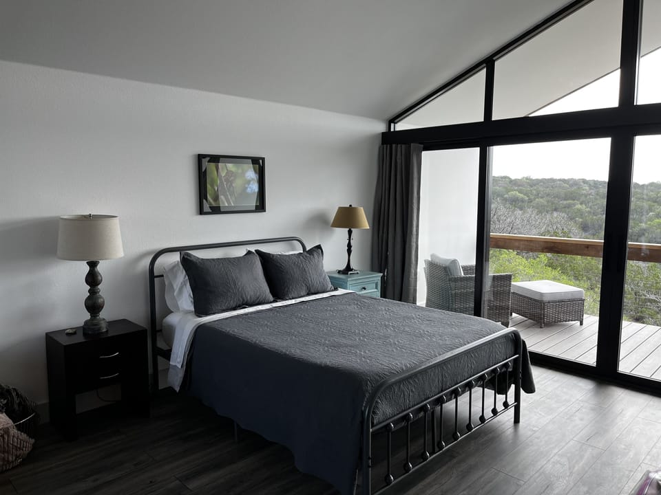 Comfy queen bed with bedside tables and lamps for reading in bed.