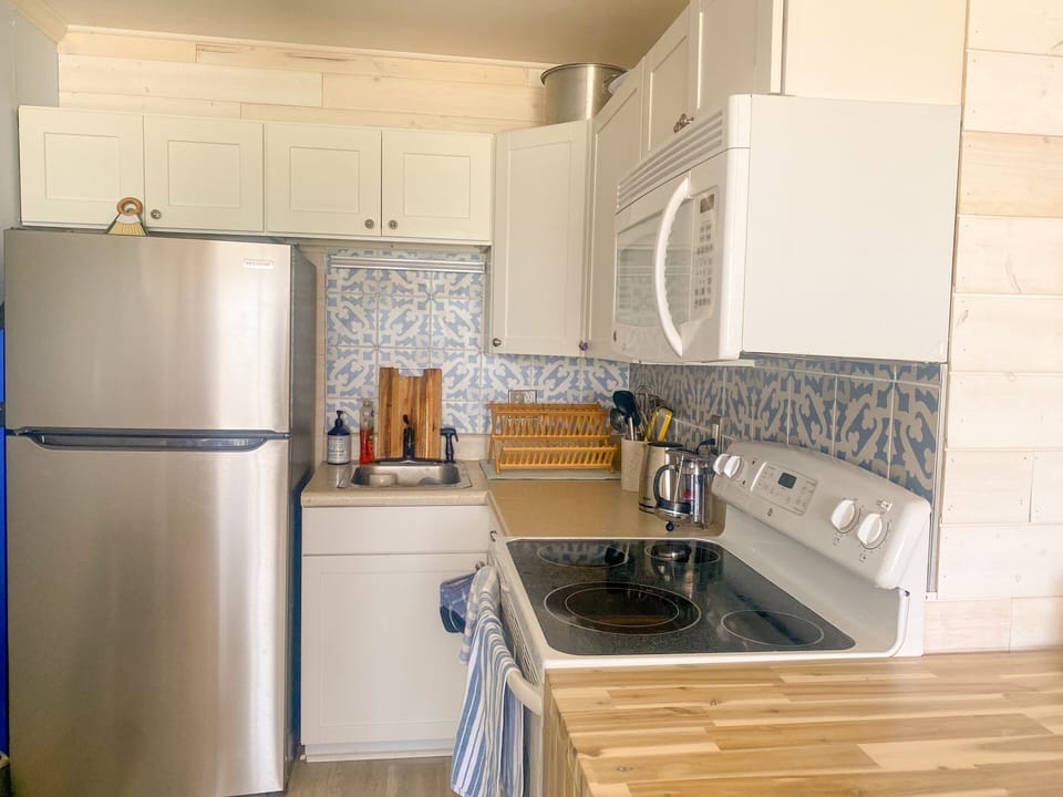 Bright kitchen with butcher block counter & stools