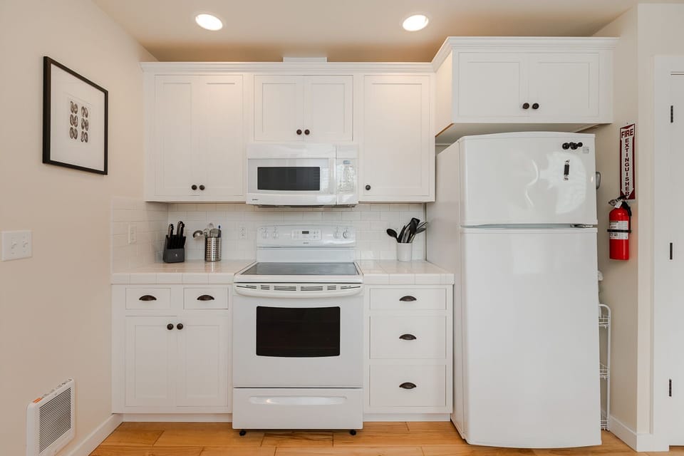 Fully stocked kitchen including many small appliances. 
