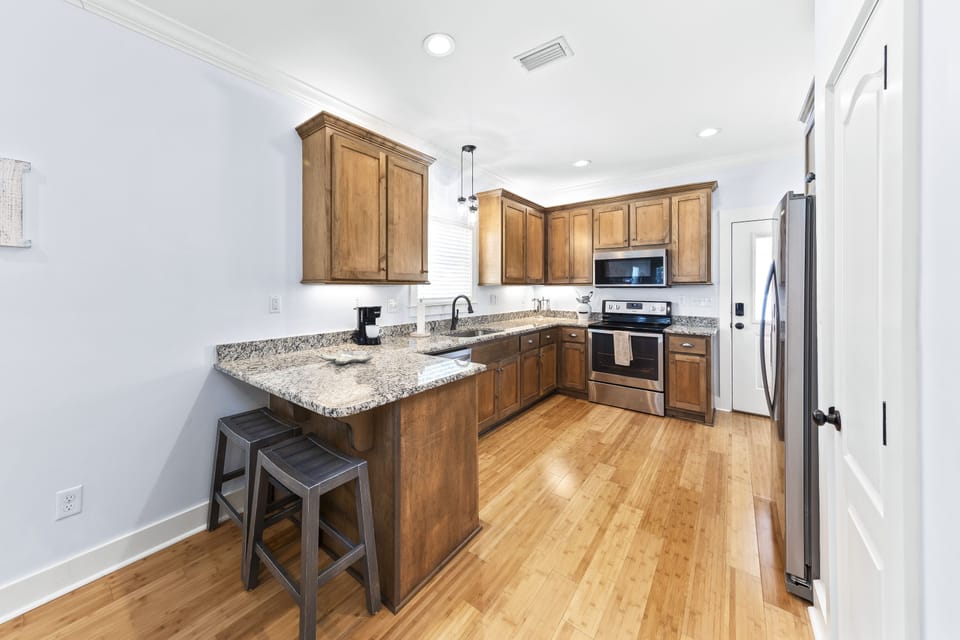 Fully-stocked kitchen with granite counters & stainless appliances