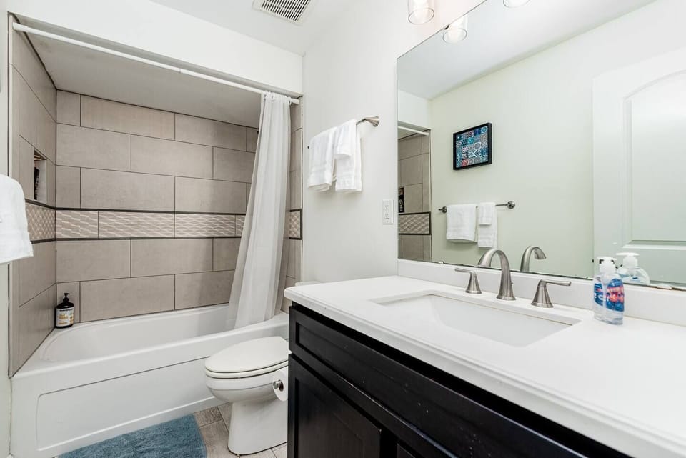 Bathroom 1 on main level with sink, toilet and shower/tub combo