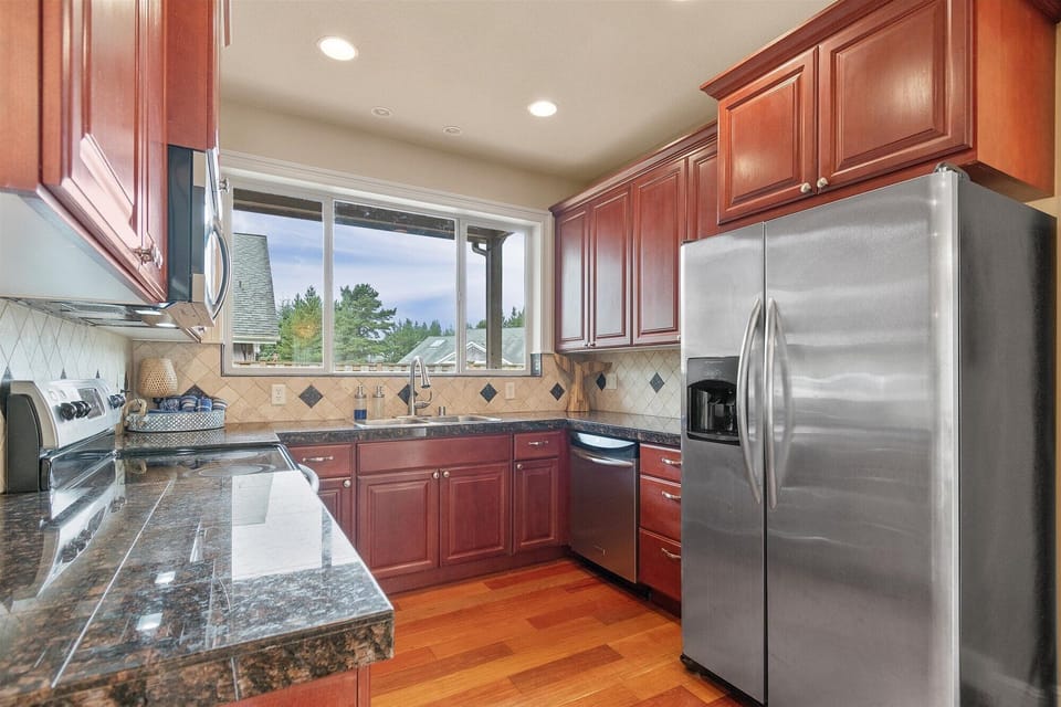 The kitchen boasts updated appliances and beautiful granite counter tops