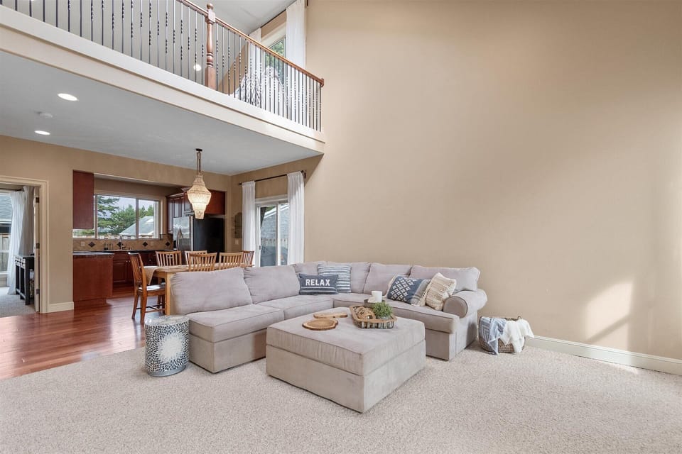 A large L-shaped couch makes the perfect separation between the living room and kitchen