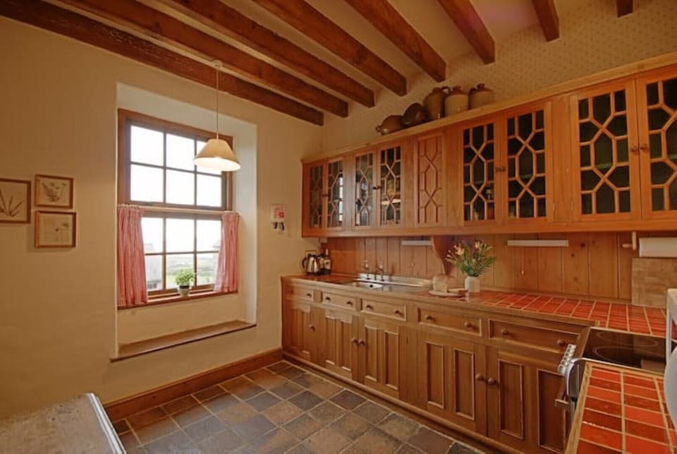 fully equipped farmhouse style kitchen with sea views