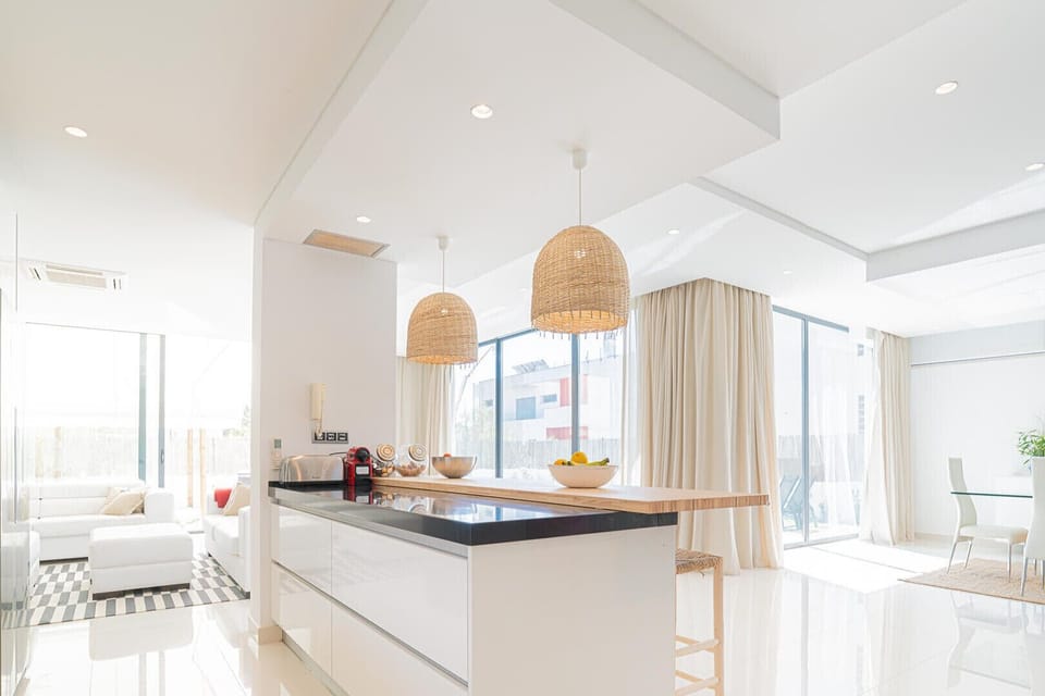 Modern open-plan kitchen and living space with woven pendant lights — Villa Melissa, luxury holiday villa in Grândola