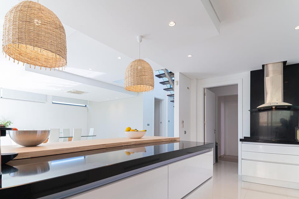 Modern open-plan kitchen with woven pendant lights — Villa Melissa, luxury holiday villa in Grândola