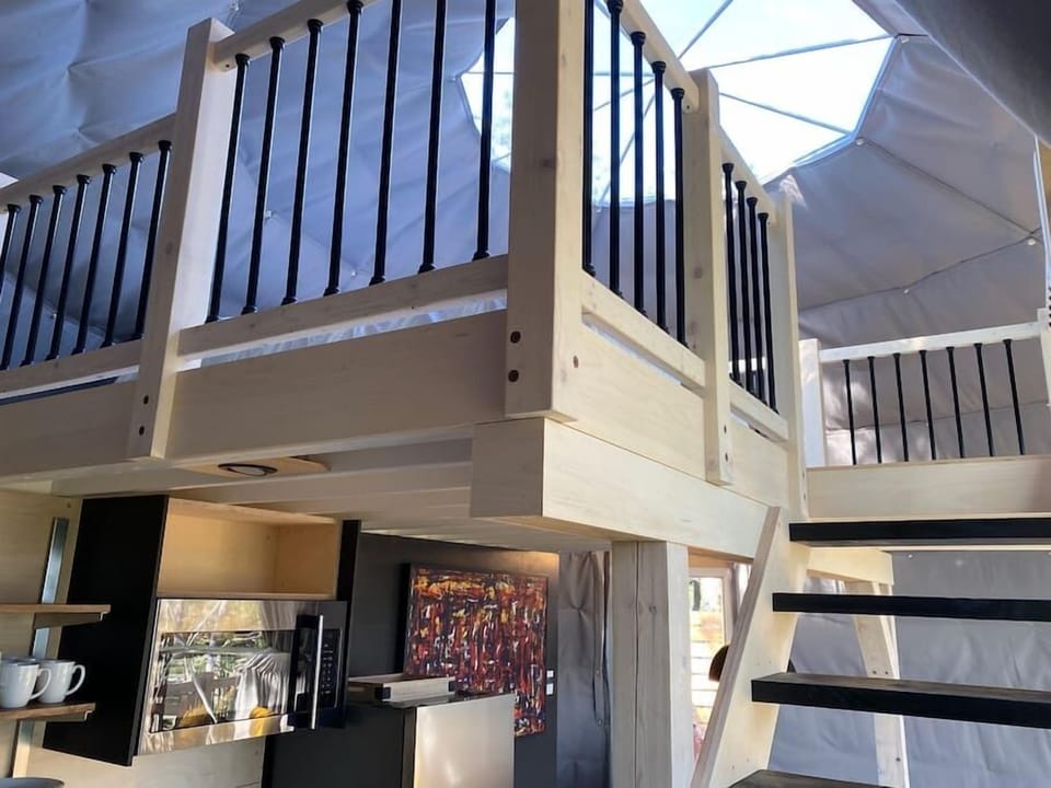 A few steps up to the mezzanine where a very large and cozy bed awaits you under the starry sky.
