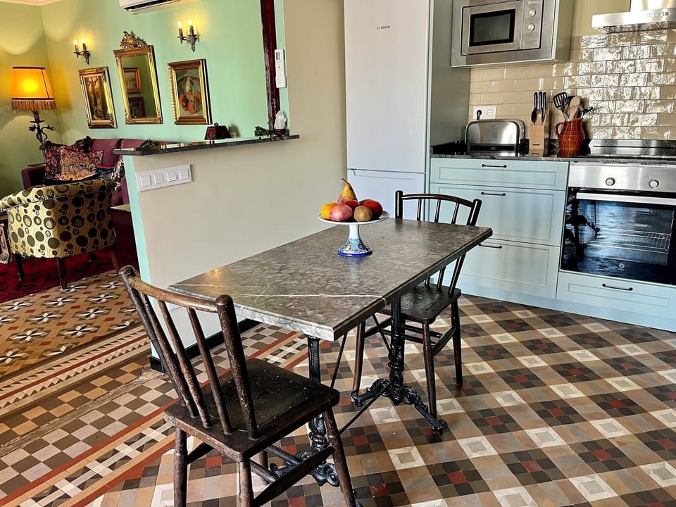 Fully-stocked chef's kitchen with views of living room and gallery