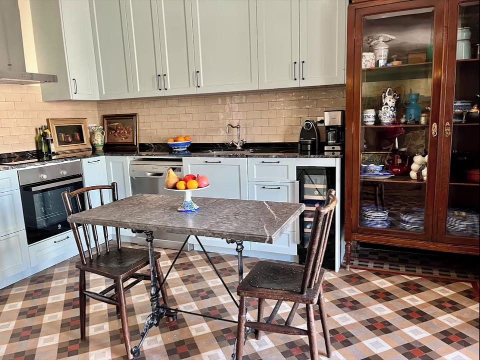 Chef's kitchen with induction stove, oven, dishwasher, refrigerator and wine cooler