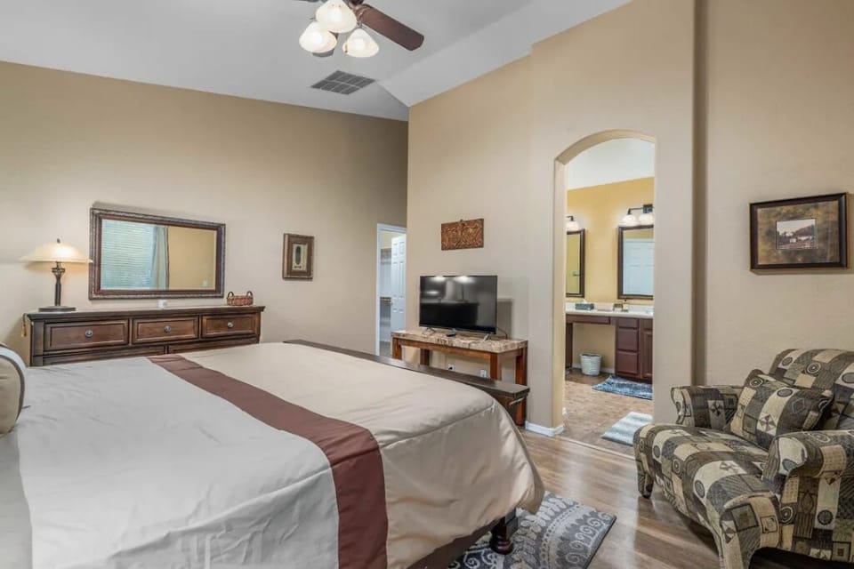 Master bedroom has walk in closet and a comfy reading chair.