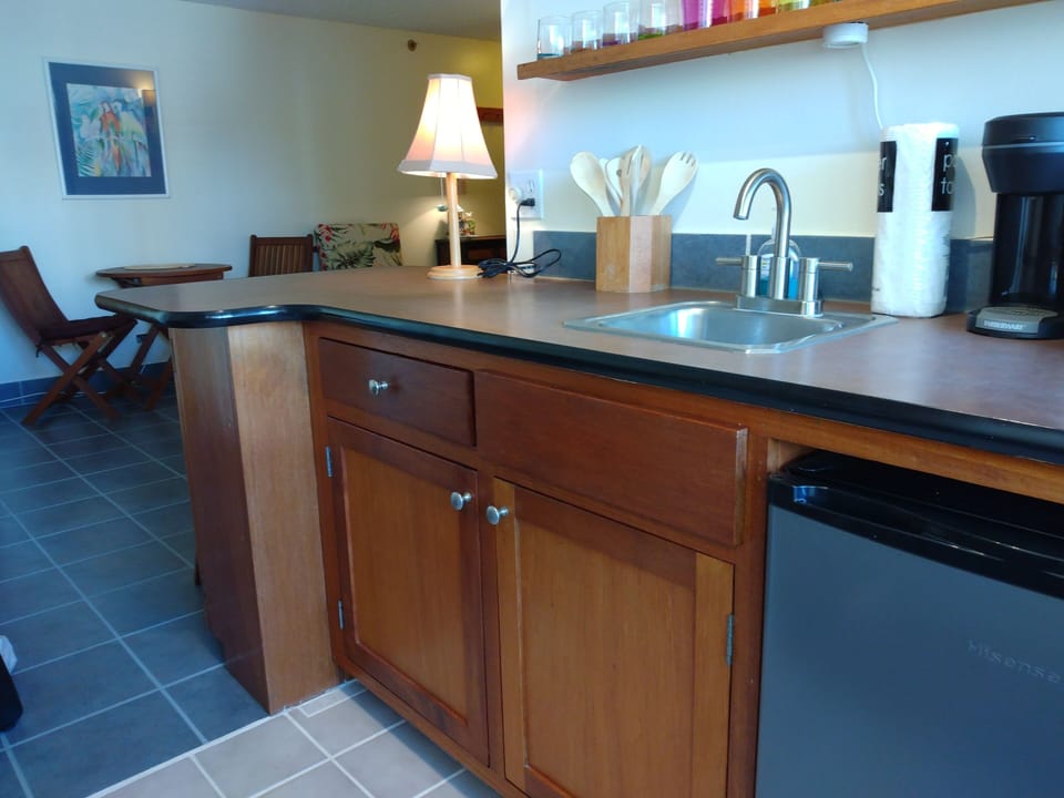 Refrigerator,  separate freezer compartment. Coffeemaker, toaster oven. 