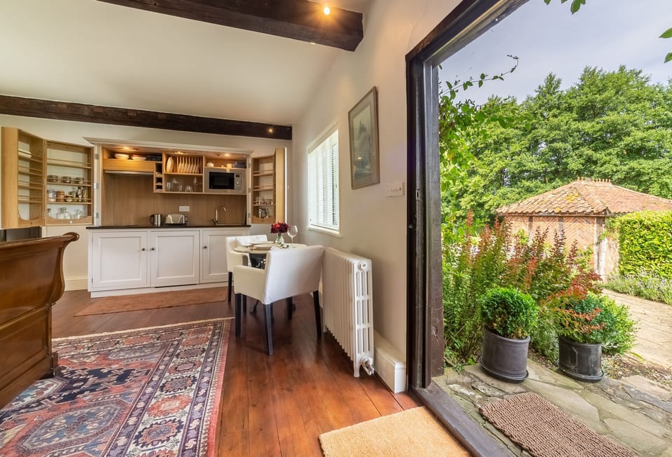 Ayres End Studio, Suffolk: Dining table and seating for two guests which looks onto the pretty English country garden