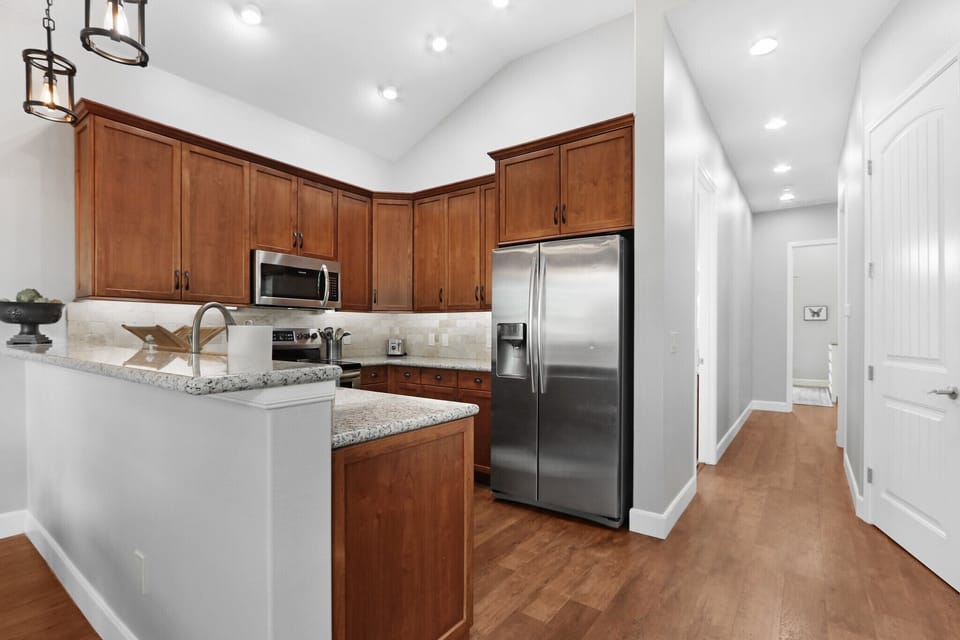 Off of the kitchen is the hallway to access the homes bedrooms