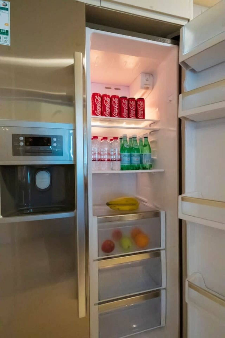 Fully stocked refrigerator: Refreshing beverages and fruits await your culinary creations!