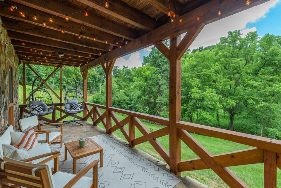 Relax on the bottom deck that overlooks the creek and firepit