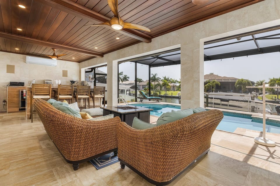 High-end comfortable seating overlooks the pool and canal.