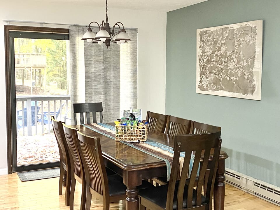 Dining table with seating for 8, sliding doors lead to backyard deck