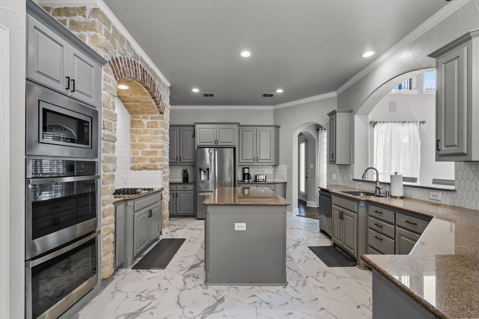 Fully Equipped kitchen with kitchen Island, connecting to living and dining area
