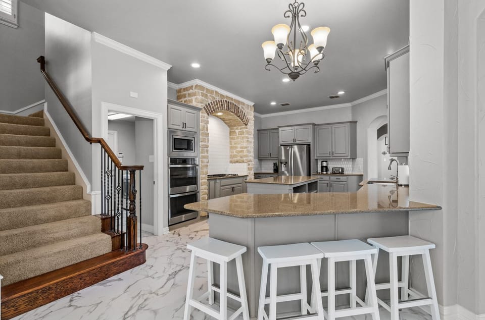 Fully equipped kitchen with stairs leading to the second floor bedrooms