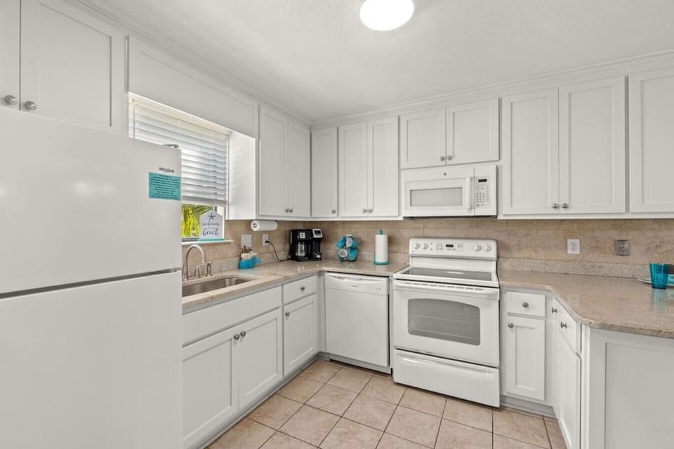 Fully-stocked kitchen with all appliances, cutely decorated with beach decor, ready for guest use!