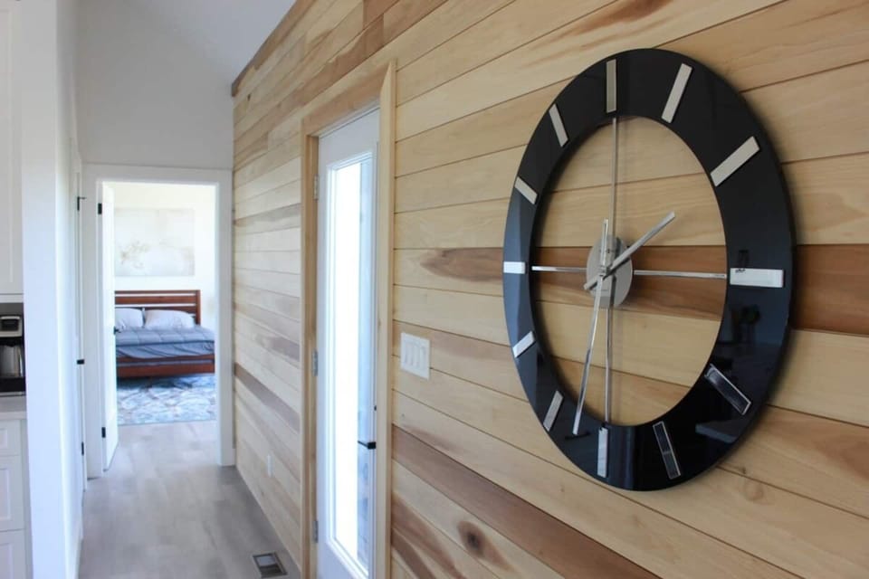 The Great Hall's clock on the birch wall is a stately and modern example of cottage timekeeping. 