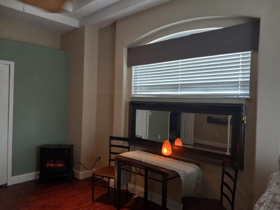 Master Bedroom:  Fireplace (far left), table & 2 chairs, Queen bed (right)