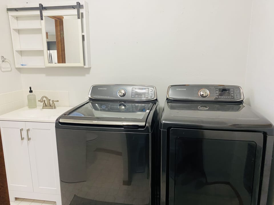 Laundry room off kitchen.  Complete with full size washer and dryer and toilet.