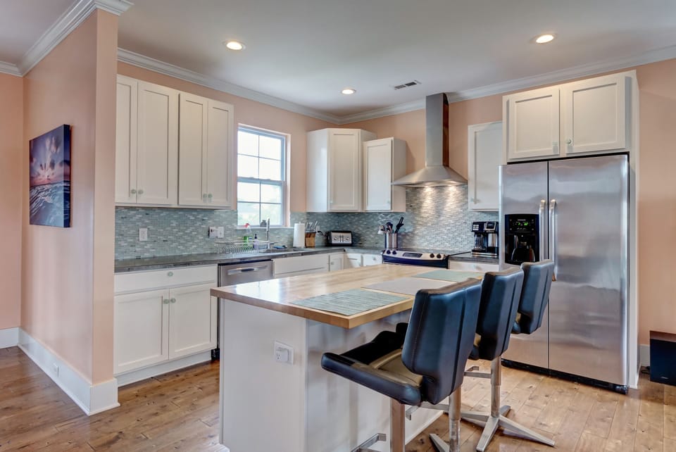 Chef's kitchen w/  turquoise backsplash, reminiscent of sea glass - pure luxury!