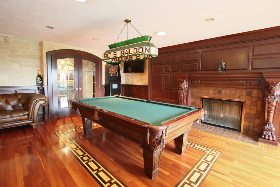 Billiards Room with Pool Table and Poker Table and Two Sides Fireplace
