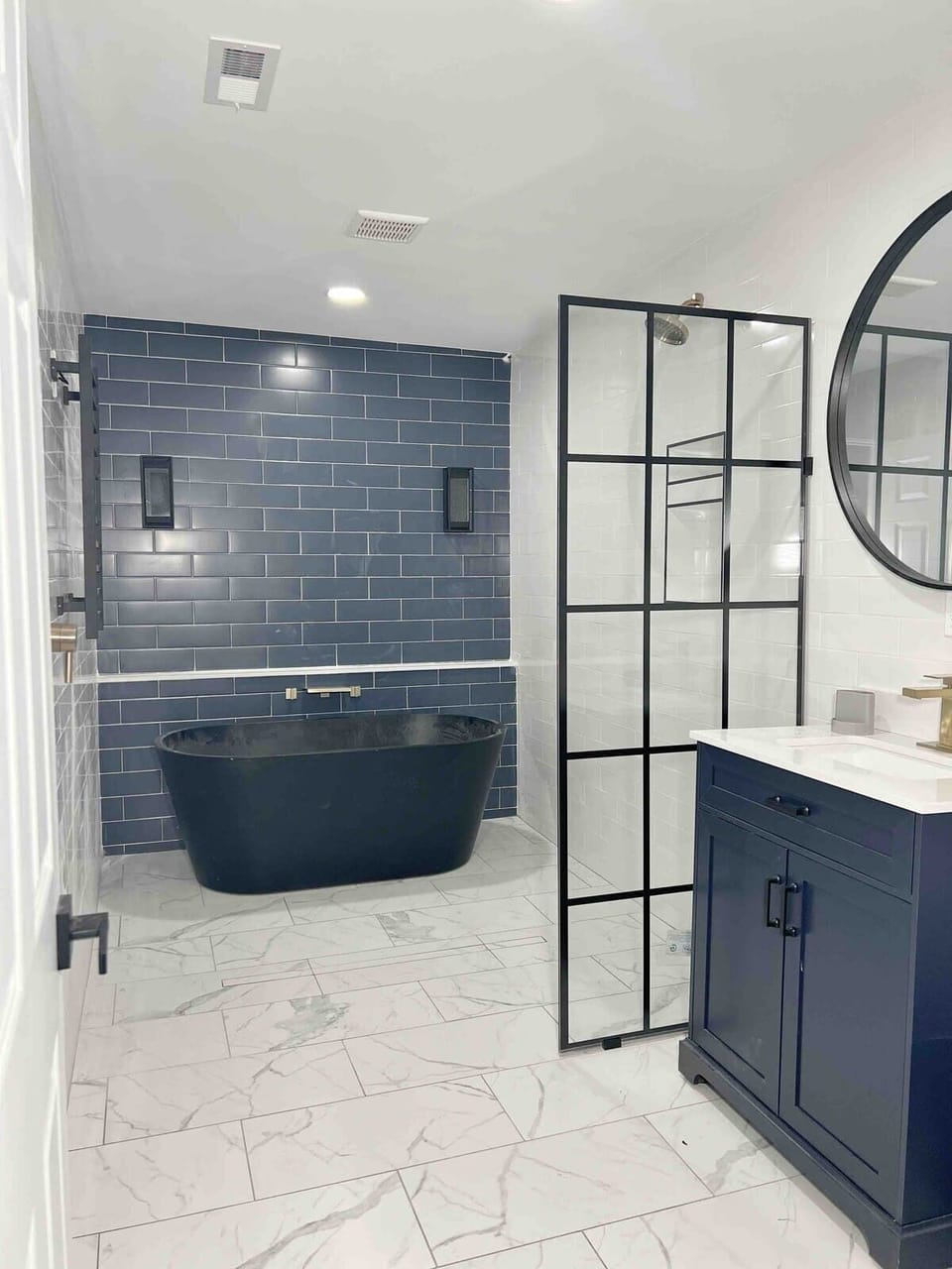 Full bathroom with glass-enclosed shower, soaking tub, and modern fixtures.