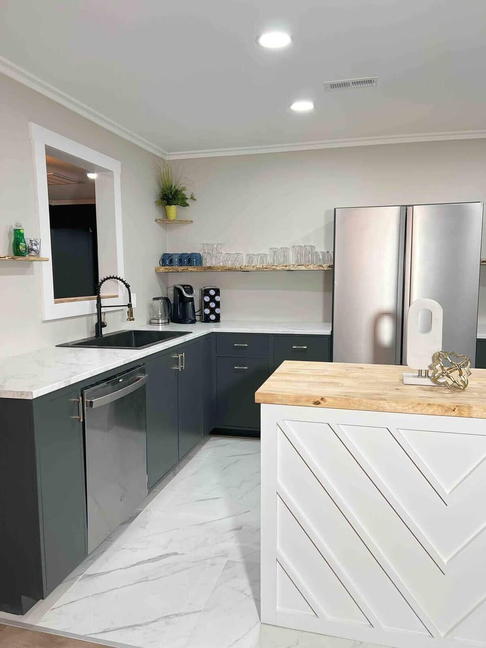 Kitchen with stainless steel appliances, modern island, and ample counter space.
