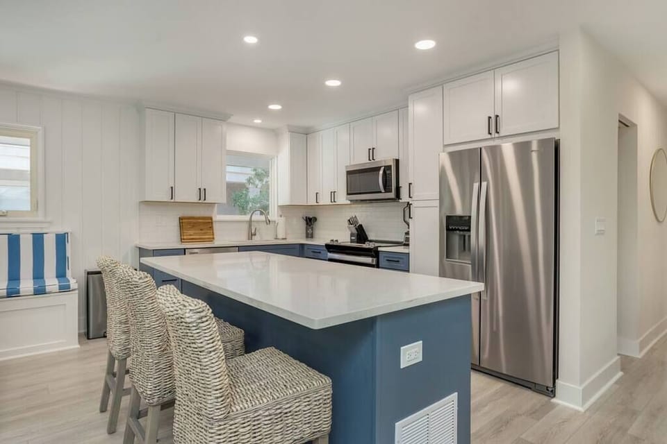 Full Kitchen with large island. Three bar stools. 