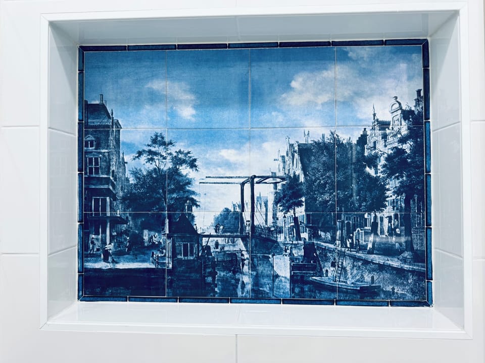 One of our genuine Delft Blue tile paintings, Old Amsterdam, as a shower mosaic 