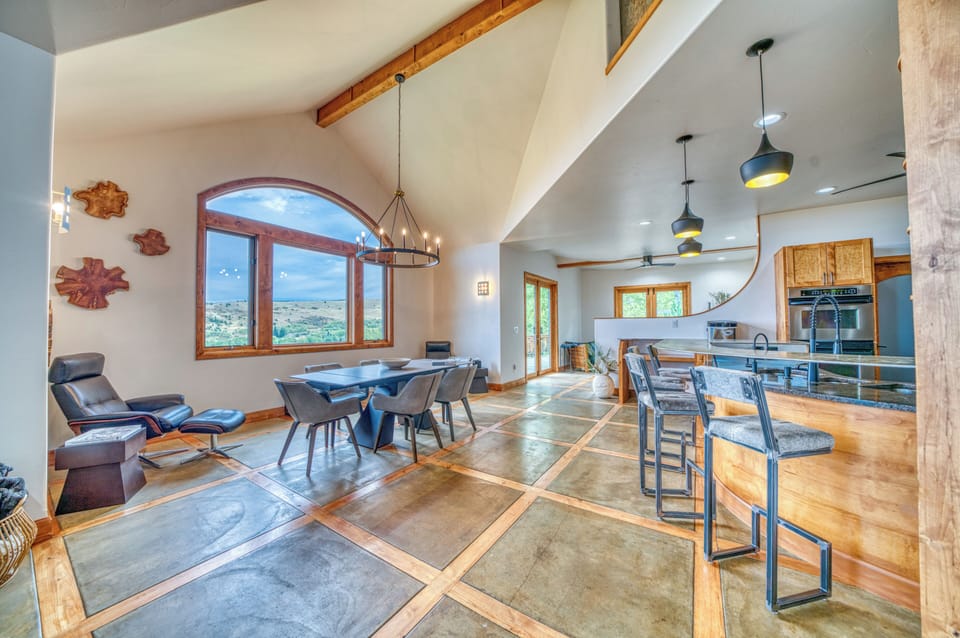 Open dining and kitchen area with stunning views, bar seating, and lounge space.